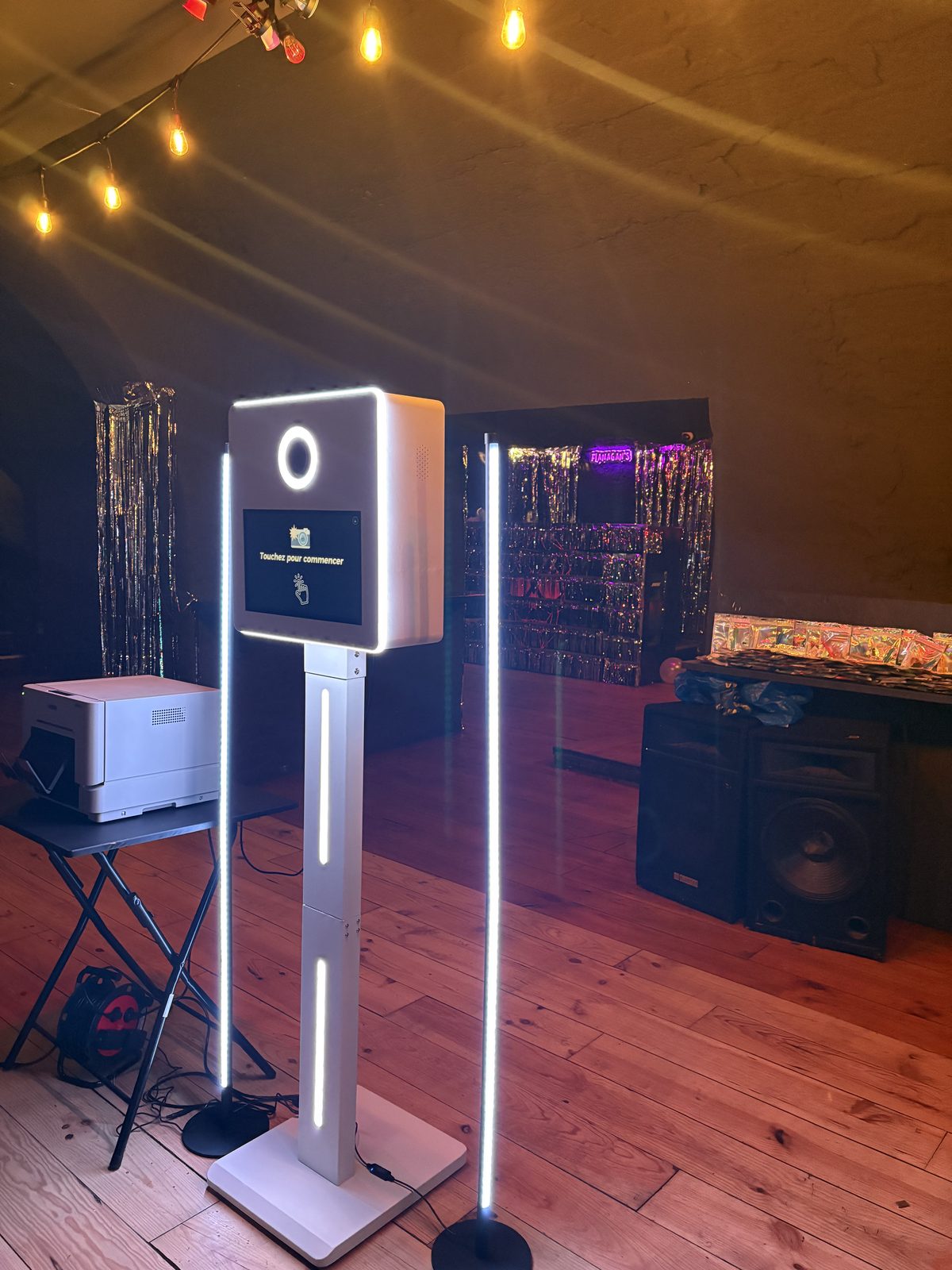 Borne photobooth Kamai installée sous des guirlandes lumineuses